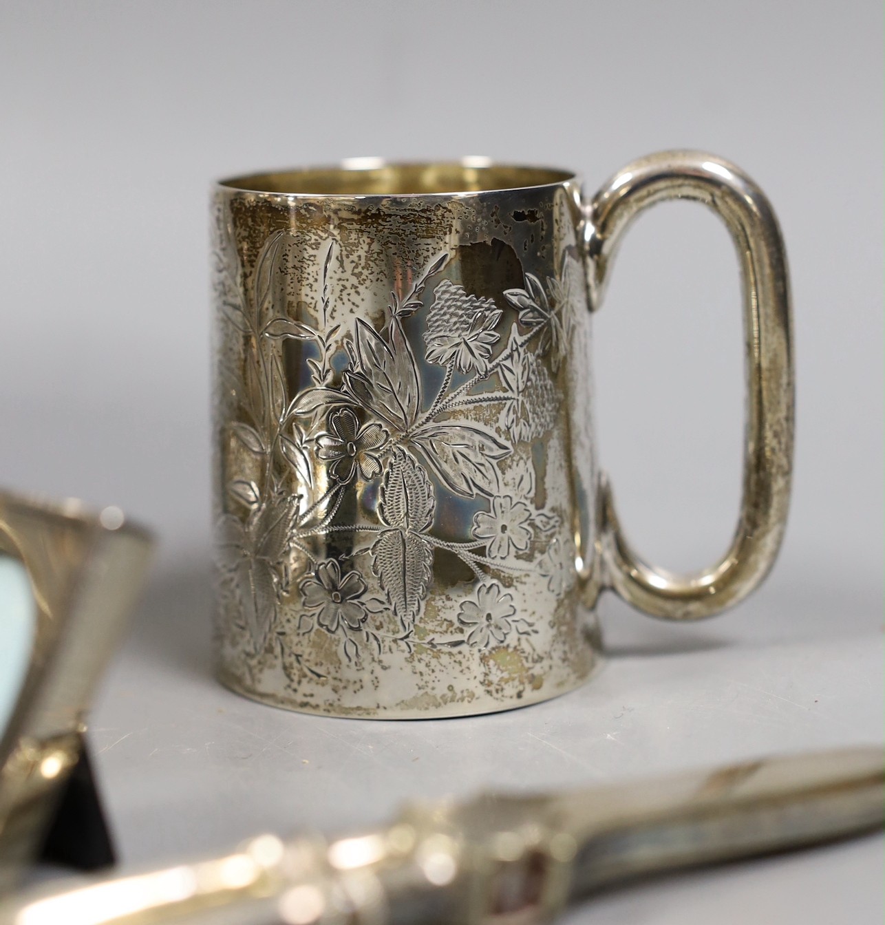 A George III silver vase shaped pepperette, Richard Evans? London, 1788, 88mm, a Victorian silver christening mug, a later silver sugar caster, a French white metal taste vin and other sundry silver and plated items.
